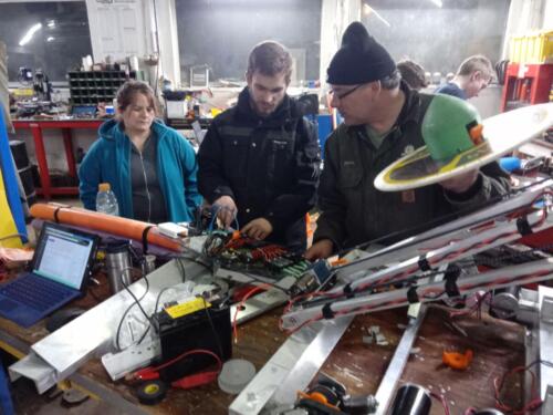 One of our team members explains the robot to his parents.
