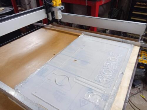 Cutting an electrinics bay cover on our CNC router.